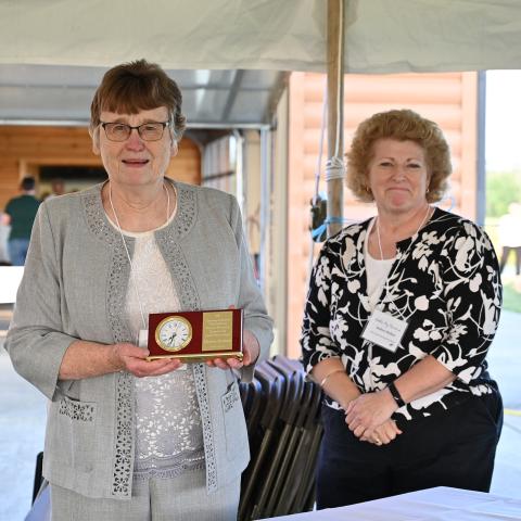 Phyllis Couture with Chuck's award and presented by Andrea Mellon